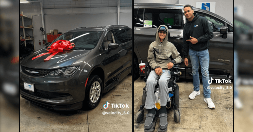 A man in a wheelchair poses with another man beside a minivan adorned with a red bow inside a garage.